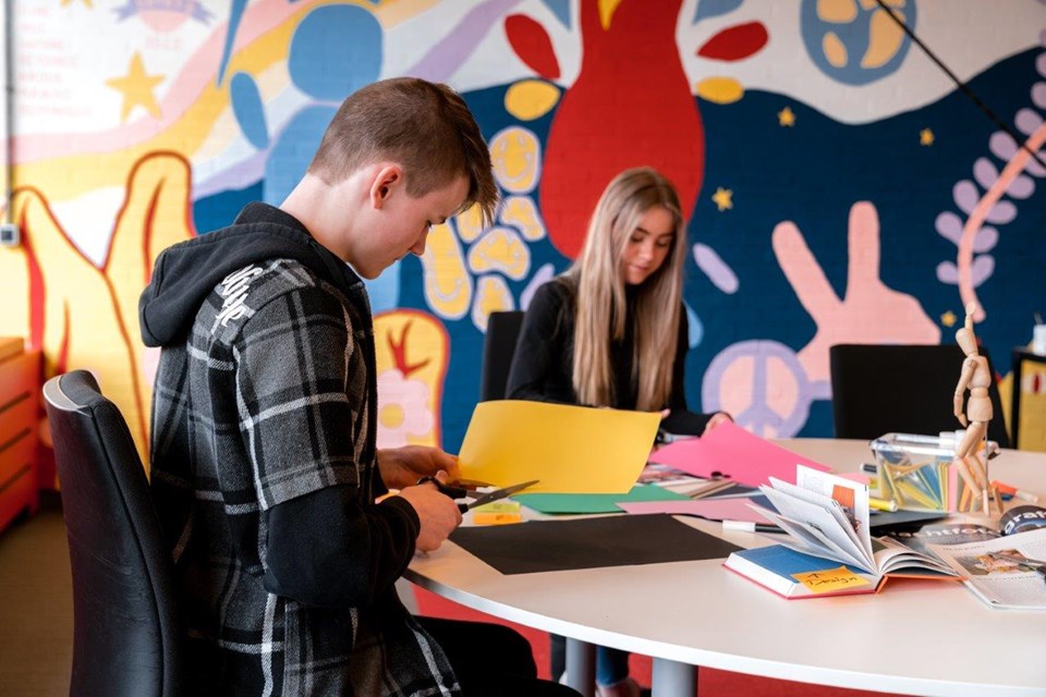 Mediavormgever, Iris Sijbom 2022 (3) Twee mediavormgevers in opleiding zitten aan ronde tafel en knippen in gekleurd papier