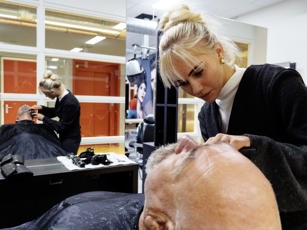 Studente aan het werk met klant tijdens de les