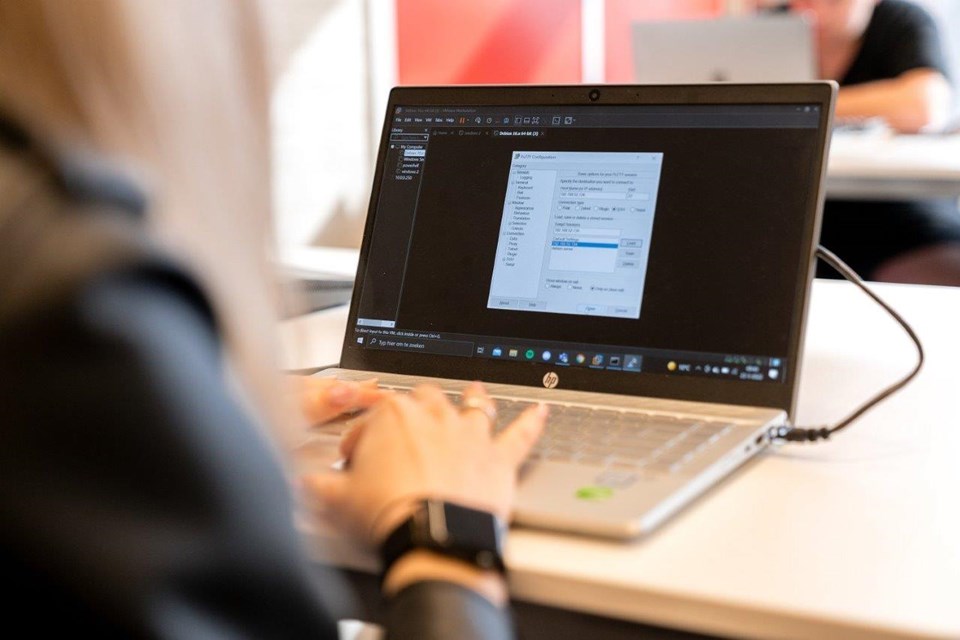 ICT Niveau 3 4 Iris Sijbom 2022 (12) Beeldscherm laptop waarachter student ICT zit